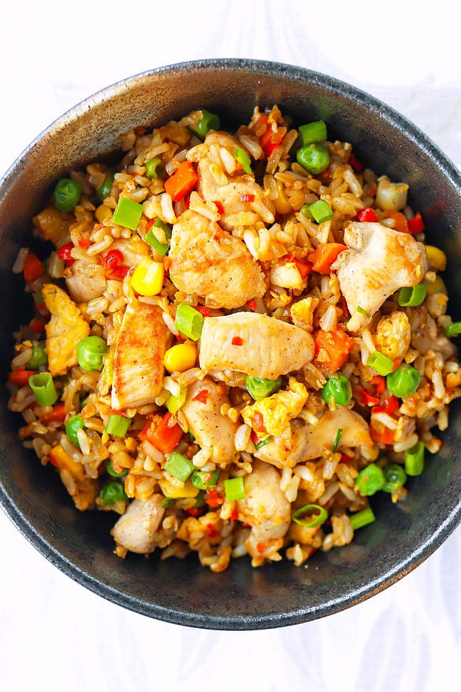Closeup of spicy chicken fried rice in a bowl.