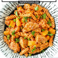 Plate with spicy creamy chicken pasta. Text overlay "High Protein Creamy Peri Peri Chicken Pasta" and "thatspicychick.com".