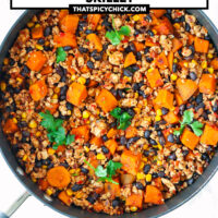 Ground chicken, sweet potato, black beans, corn garnished with coriander in a skillet. Text overlay "Mexican Chicken Sweet Potato & Black Bean Skillet" and "thatspicychick.com".