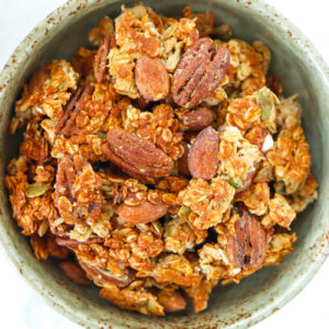 Closeup of peanut butter banana protein granola clusters in a bowl.