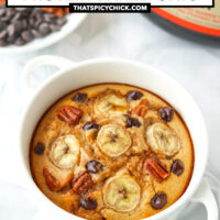 Banana bread baked oats in a ramekin with handles. Text overlay "Banana Bread Protein Baked Oats" and "thatspicychick.com".