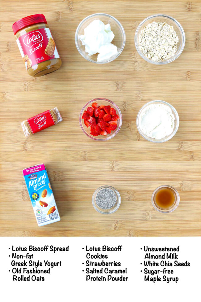 Labeled ingredients for Biscoff Protein Overnight Oats on a wooden board.
