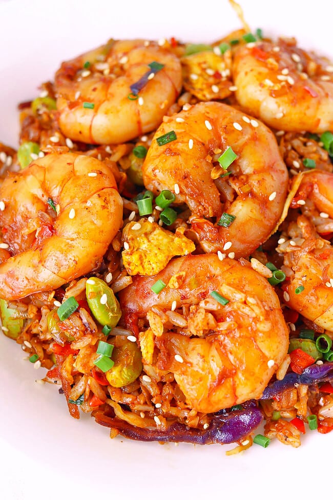 Closeup front view of plate with spicy gochujang shrimp fried rice.