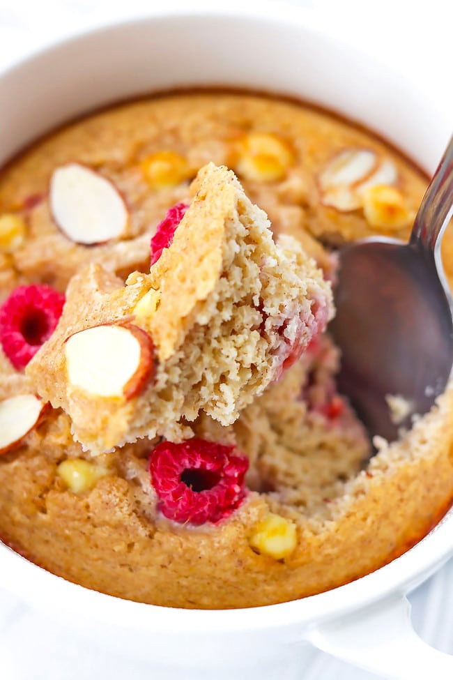 Spoon inside ramekin to show cake-like texture of raspberry white chocolate baked oatmeal.