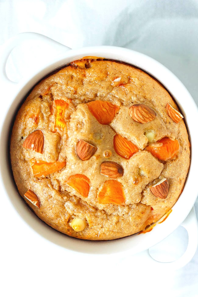 Closeup top view of Apricot Almond Baked Oats in a white ramekin with handles.