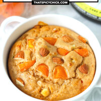 Baked oats in a ramekin and protein powder tub behind. Text overlay "Apricot Almond Protein Baked Oats" and "thatspicychick.com".