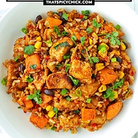 Plate with Mexican fried rice. Text overlay "Mexican Fried Rice with Chicken" and "thatspicychick.com".