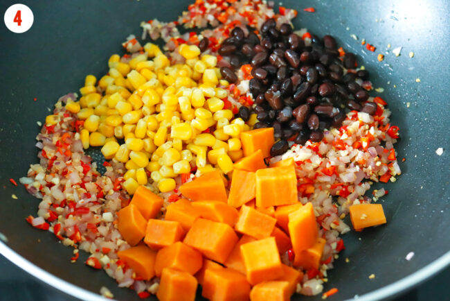 Added corn, black beans, and sweet potatoes to wok with aromatics.