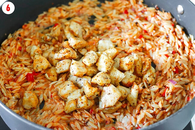 Added cooked chicken pieces to pan with creamy spiced tomato sauce and orzo.