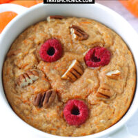 Front view of baked oats in a ramekin and carrots in the background. Text overlay "Carrot Cake Baked Oats" and "thatspicychick.com".