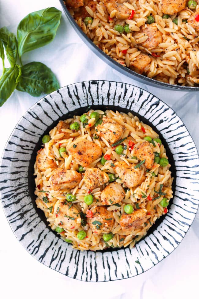 Plate and pan with chicken orzo in a lemon cream sauce.