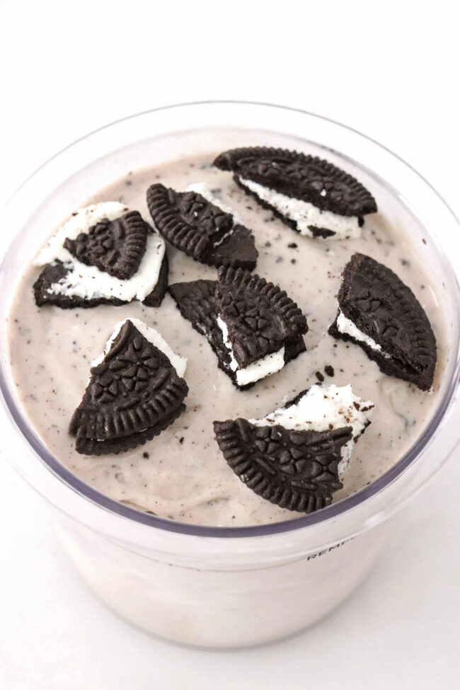 Front view of oreo ice cream topped with crushed oreos in a Ninja Creami pint.