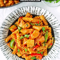 Plate and pan with chicken pasta. Text overlay "One Pot Chicken Fajita Pasta" and "thatspicychick.com".