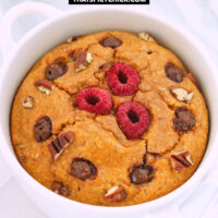 Closeup front view of baked oatmeal in a ramekin. Text overlay "Pumpkin Baked Oats", "Single Serving + High Protein", and "thatspicychick.com".