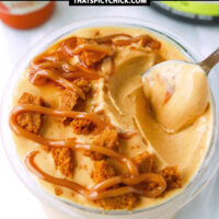 Spoon in pint with pumpkin pie protein ice cream, caramel syrup and crushed Biscoff cookie. Text overlay "Ninja Creami Pumpkin Pie Ice Cream" and "thatspicychick.com".