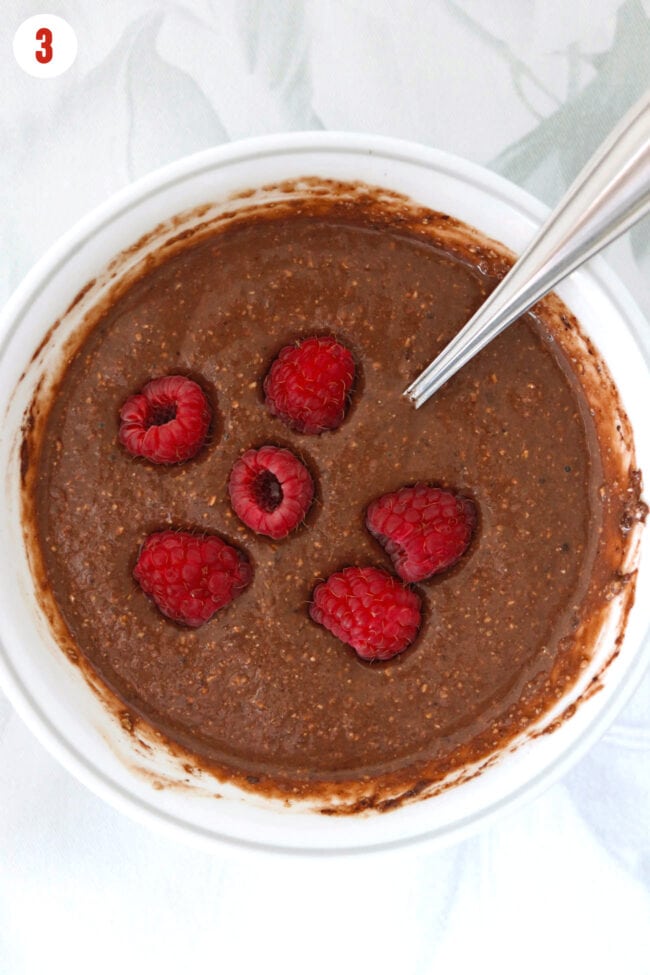 Added raspberries to bowl with protein chocolate baked oats batter.