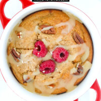 Top view of ramekin with cinnamon roll baked oats drizzled with sweetened condensed milk. Text overlay "Cinnamon Roll Baked Oats" and "thatspicychick.com".