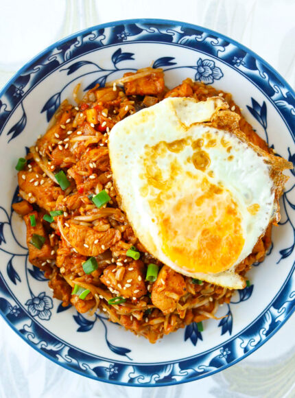Top view of plate with kimchi chicken fried rice topped with a fried egg.