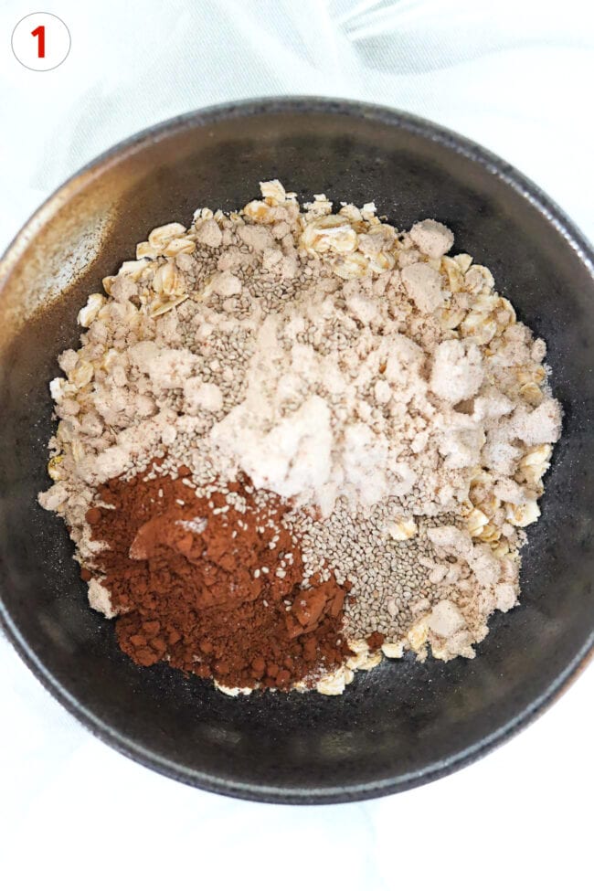Cocoa powder, protein powder, chia seeds, oats and salt in a bowl.