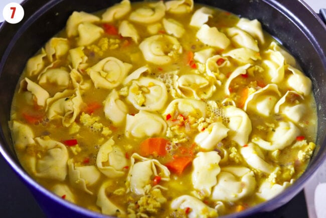 Added tortellini to simmering soup in pot.