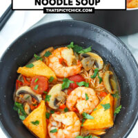 Spicy noodle soup with shrimp and fish blocks in a bowl and pot. Text overlay "Thai Tom Yum Noodle Soup" and "thatspicychick.com".