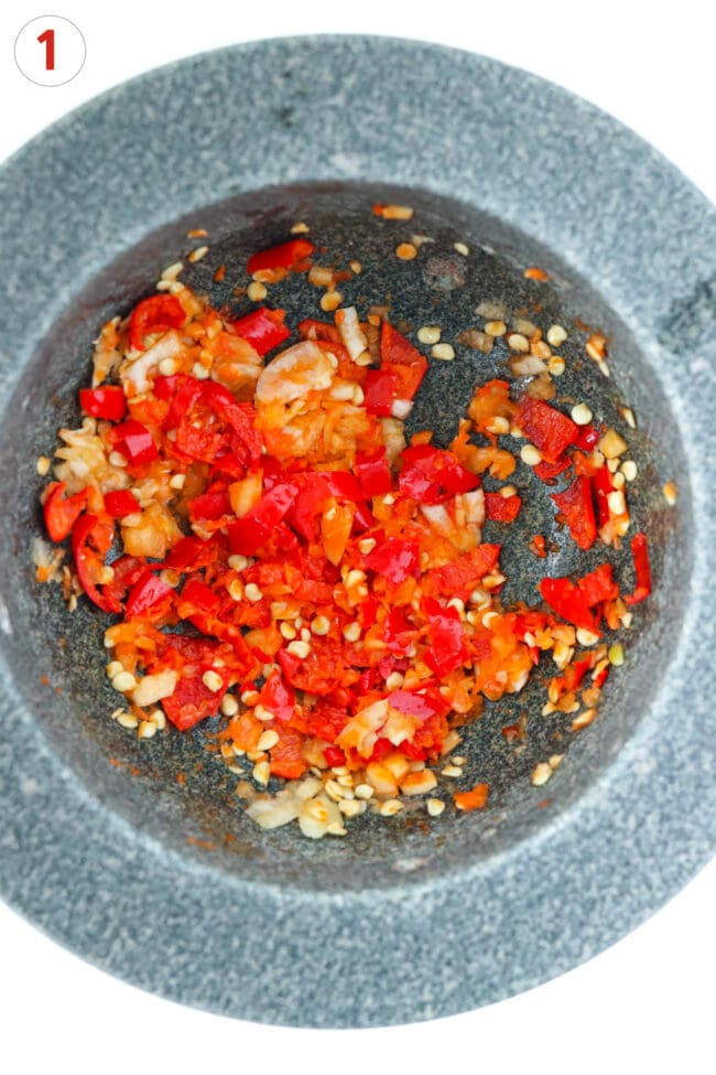 Smashed chilies and garlic paste in mortar.
