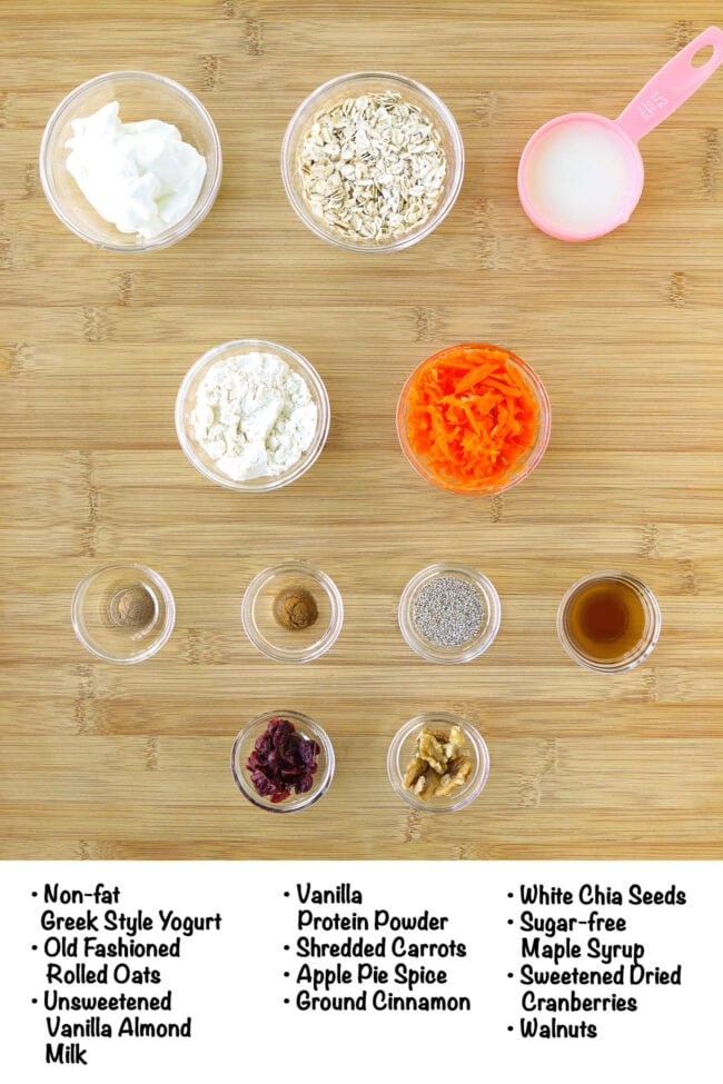 Labeled ingredients for carrot cake oats on a wooden board.