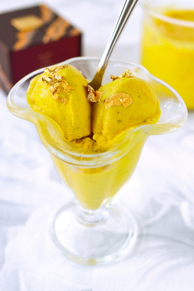 Ninja Creami Golden Milk Ice Cream in ice cream dish with spoon.