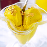 Ninja Creami Golden Milk Ice Cream in ice cream dish with spoon closeup.
