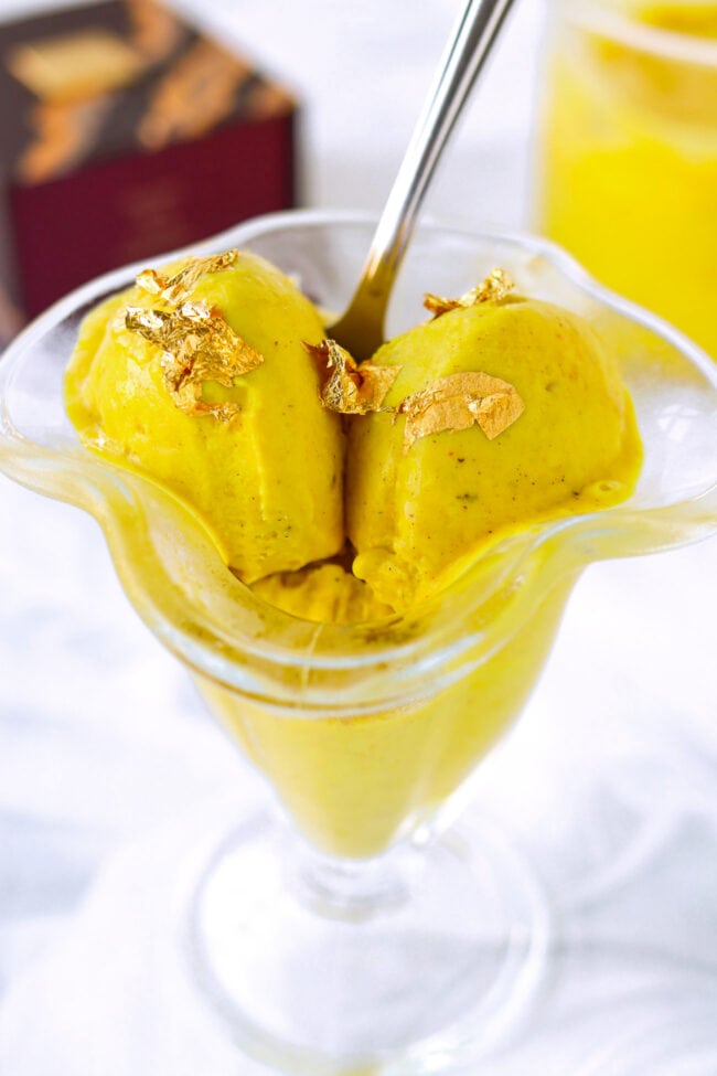Ninja Creami Golden Milk Ice Cream in ice cream dish with spoon closeup.