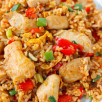 Closeup front view of spicy fried rice on a plate. Text overlay "Sambal Chicken Fried Rice" and "thatspicychick.com".