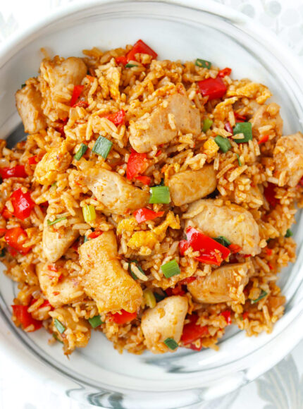 Closeup of sambal fried rice with chicken on a plate.