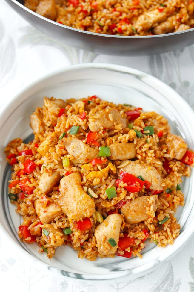 Sambal chicken fried rice on a plate and in a wok.