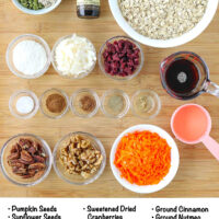 Labeled ingredients for carrot cake granola on a wooden board.