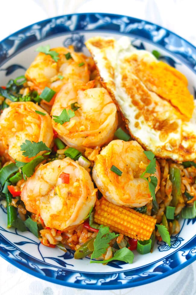 Tom yum fried rice with shrimp on a plate closeup.
