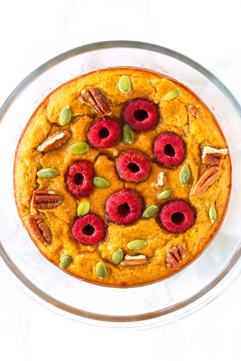 Baked Pumpkin Protein Pancake Bowl with Cottage Cheese with maple syrup in a round glass baking dish.