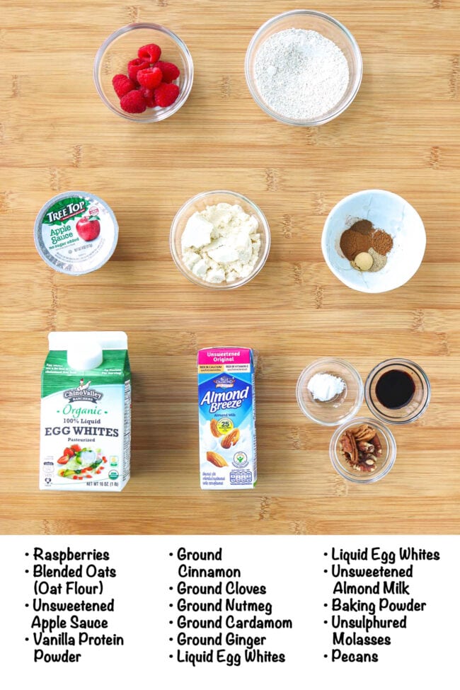 Labeled ingredients for gingerbread baked oats on a wood board.