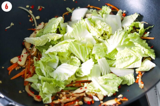Chinese cabbage in wok with stir-fried vegetables.