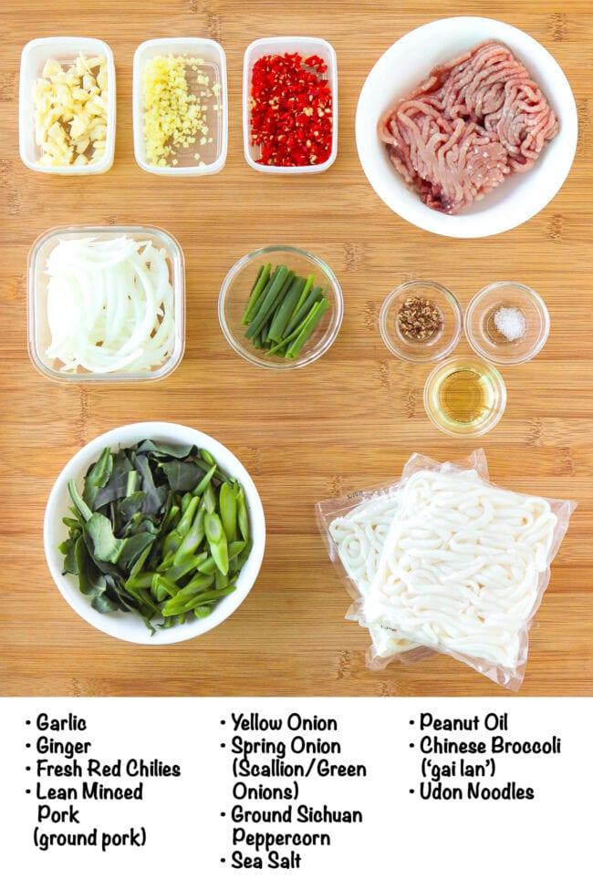 Labeled ingredients for Sichuan Pork and Broccoli Noodles on a wood board.