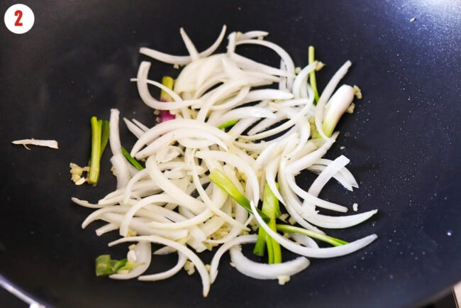 Stir fried yellow onion, ginger and pale green parts of green onions.