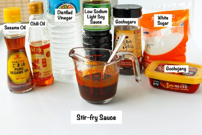 Labeled stir-fry sauce ingredients for creamy kimchi chicken udon noodles.