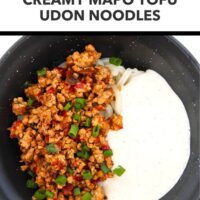 Black bow with spicy minced pork, noodles, and silken tofu sauce. Text overlay "Easy Weeknight Dinner!", "Creamy Mapo Tofu Udon Noodles" and "That Spicy Chick".