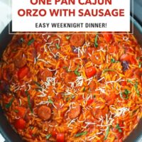 Top view of Cajun orzo with peppers and sausage in a skillet. Text overlay "One Pan Cajun Orzo with Sausage", "Easy Weeknight Dinner!", and "That Spicy Chick".