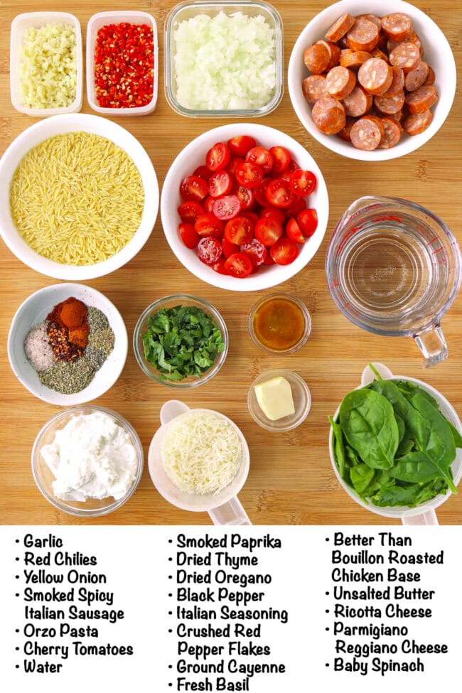 Labeled ingredients for One Pan Spicy Italian Sausage Orzo on a wood board.