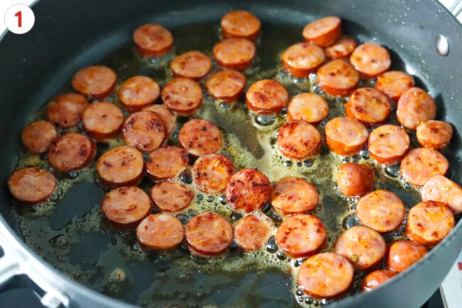 Cooking sliced spicy Italian sausage in a large pan.