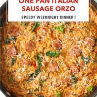 Closeup of creamy sausage orzo in a pan garnished with basil. Text overlay "One Pan Italian Sausage Orzo", "Speedy Weeknight Dinner!!" and "That Spicy Chick".
