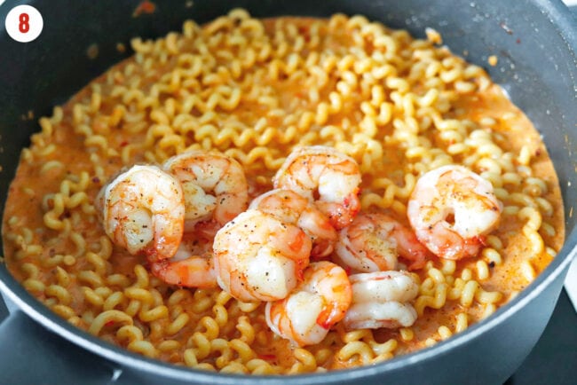 Cooked shrimp in pan with creamy Calabrian chili pasta.