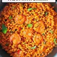 Top view of pan with Calabrian chili pasta. Text overlay "Creamy Calabrian Chili Pasta with Shrimp" and "That Spicy Chick".