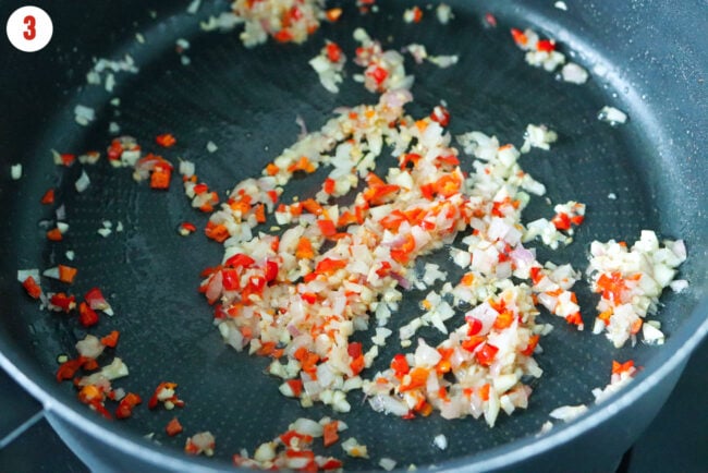 Sautéed chopped shallots, garlic and red chillies in unsalted butter in a pan.