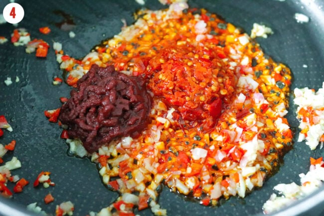 Calabrian chili paste and double concentrated tomato paste added to pan with sautéed shallots, garlic and red chilies.